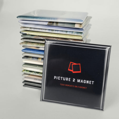 Stack of photo magnets with a 'Picture 2 Magnet' product in front on a light gray background