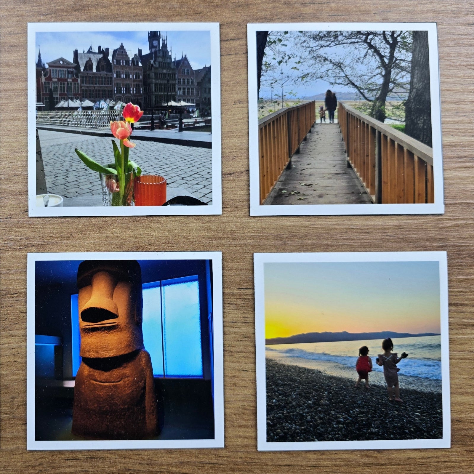 Collection of four magnet photo prints on a wooden surface