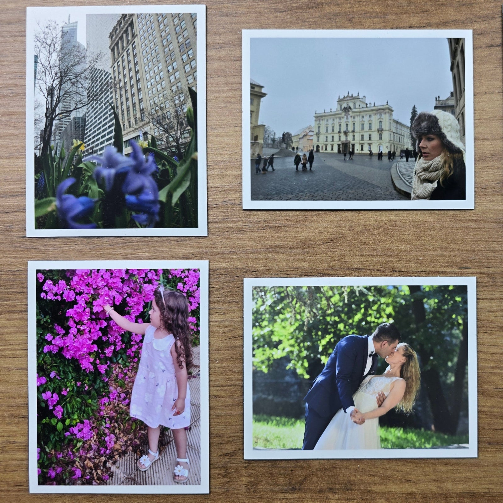 Set of four photo magnet prints on a wooden surface