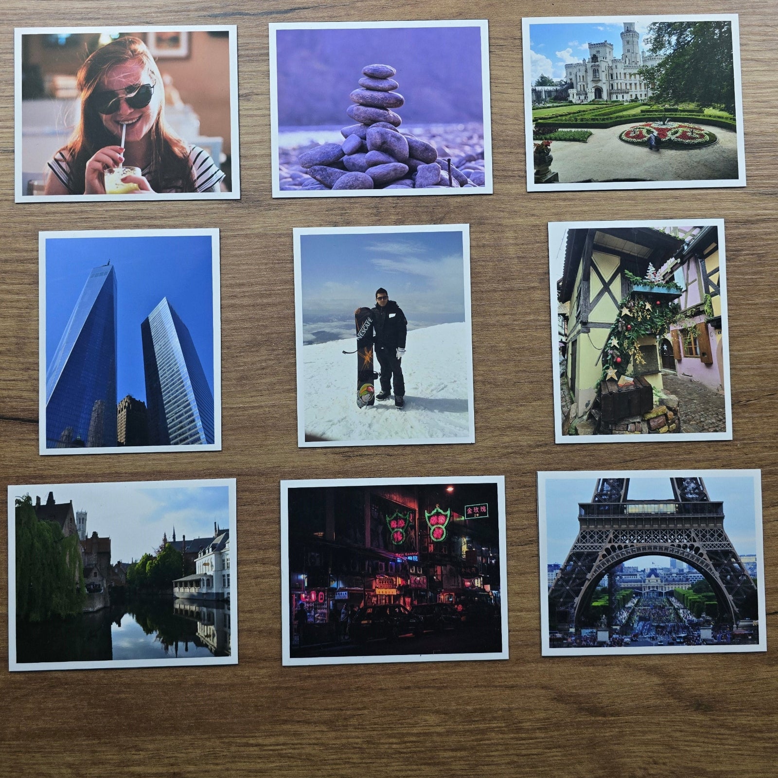 Collection of scenic and lifestyle magnet photos arranged on a wooden surface