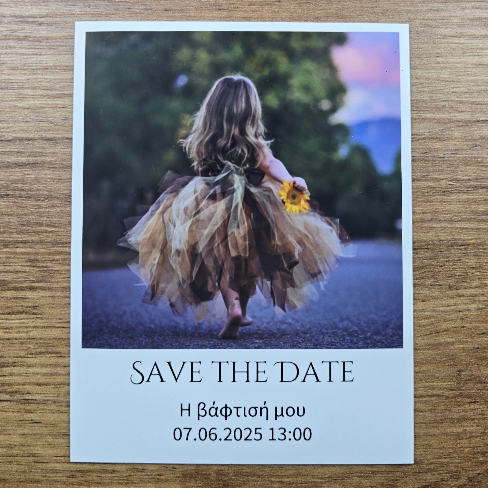 Save the date photo magnet with a photo of a woman in a dress on a wooden surface