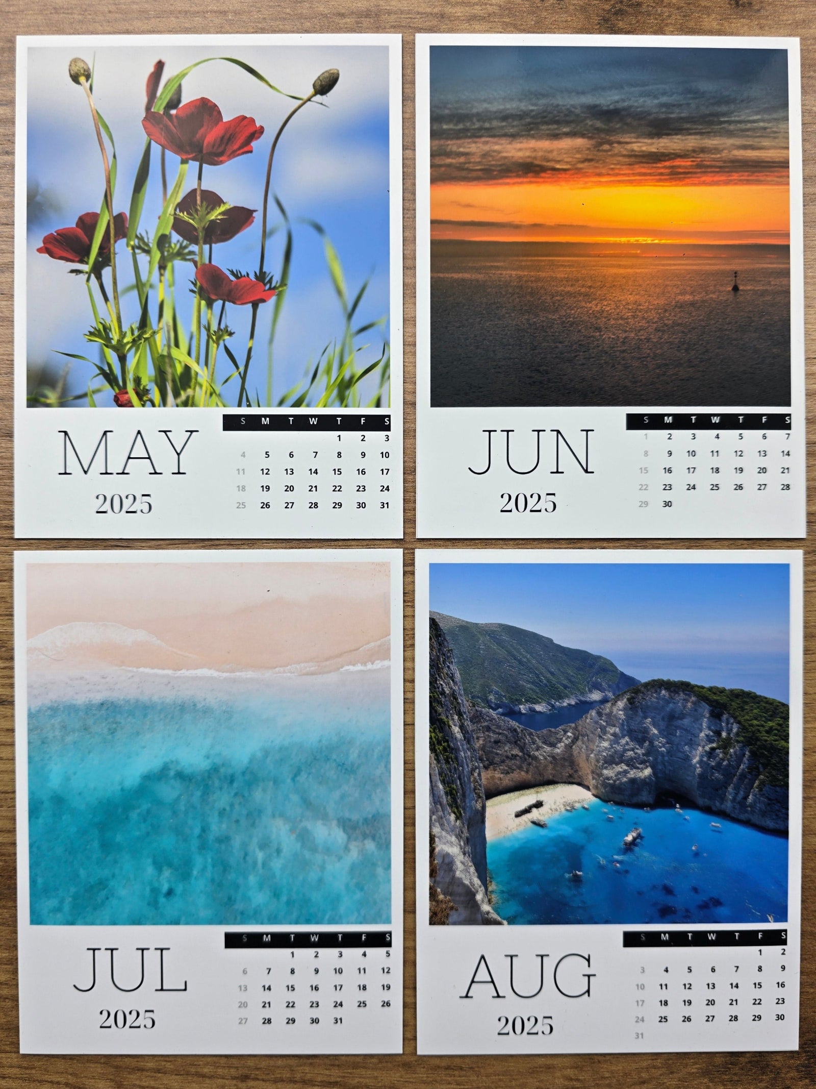 Four-month photo magnet calendar showing June, August, May, and July with scenic images.