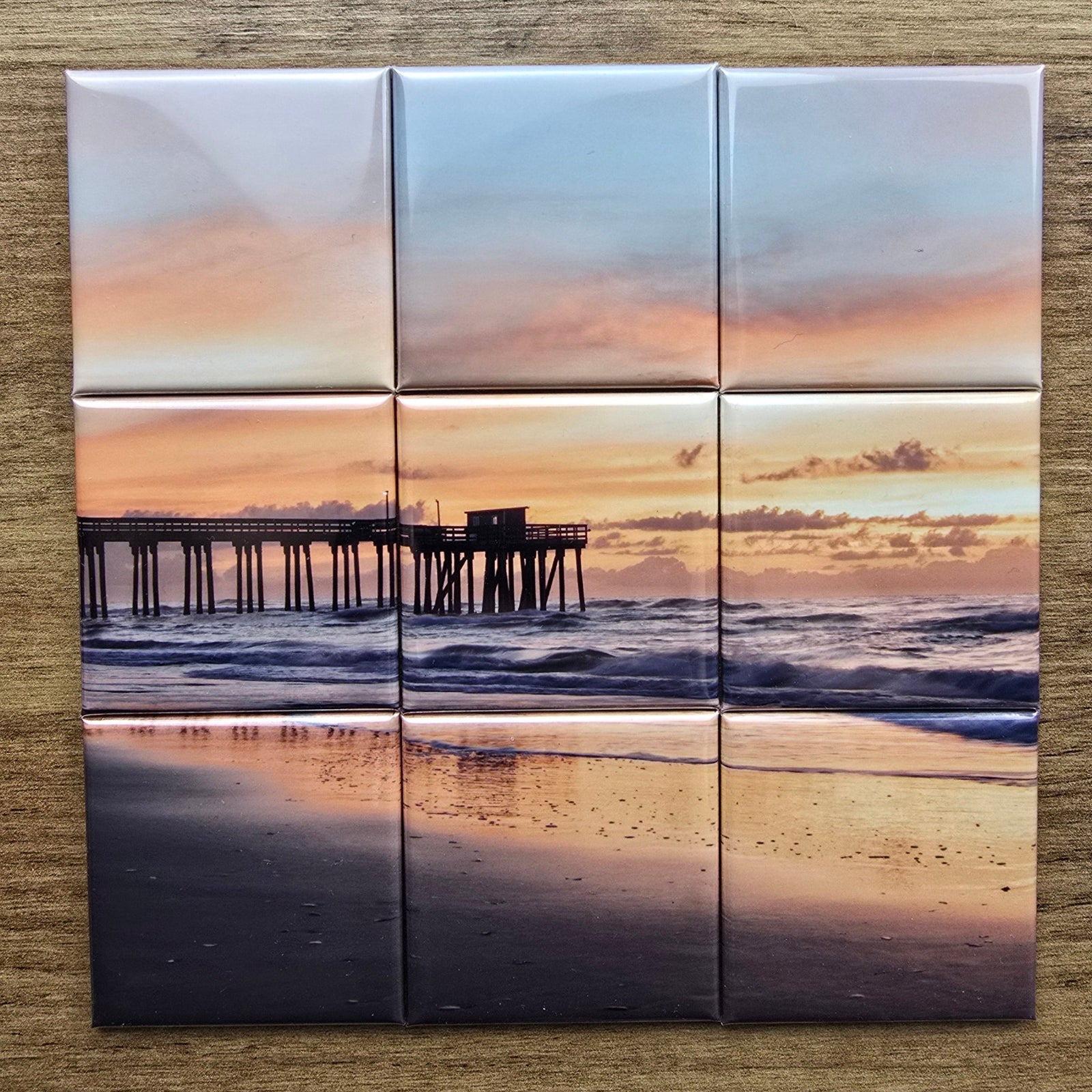 Set of six square photo magnets tiles with a beach scene design on a wooden surface