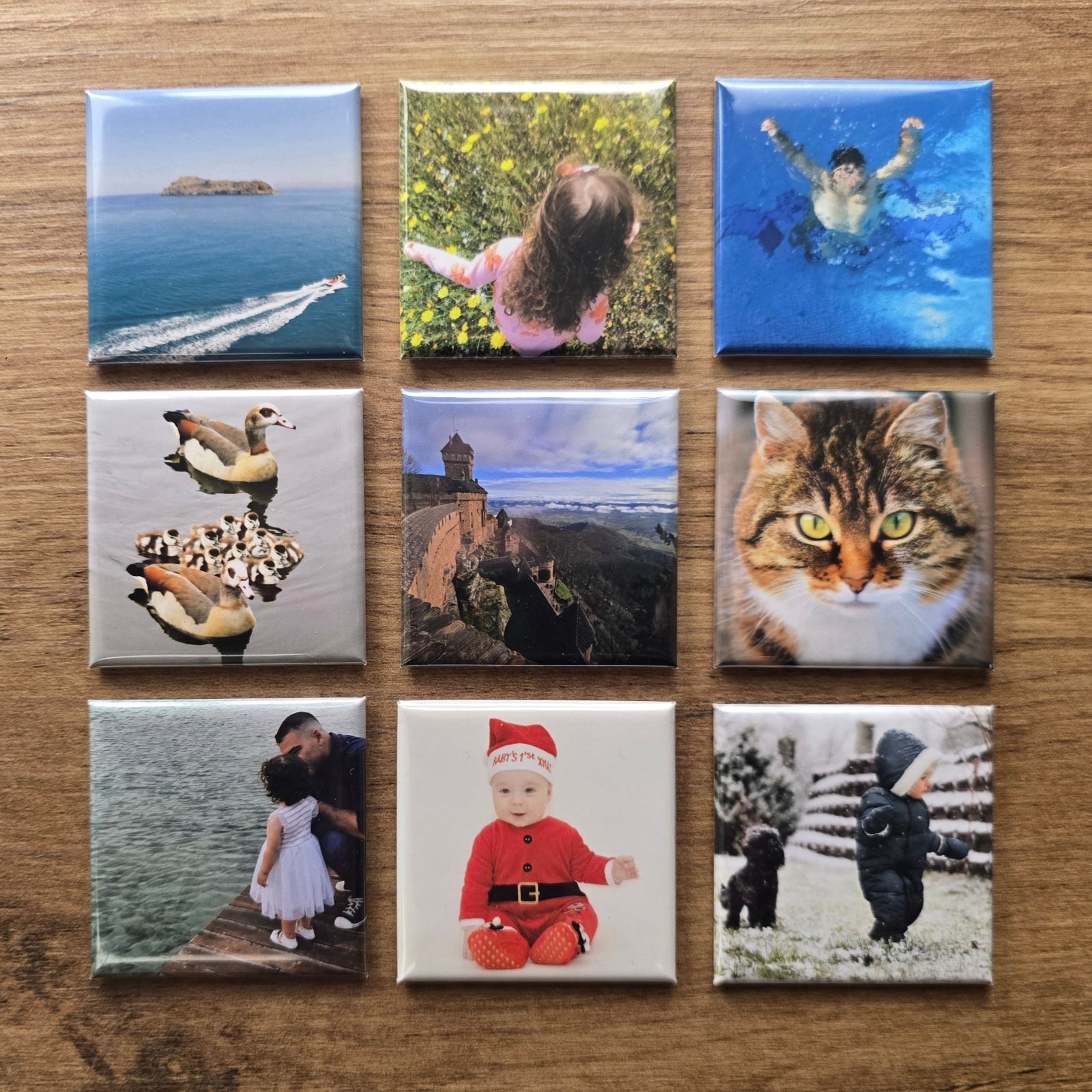 Collection of square photo magnets on a wooden surface