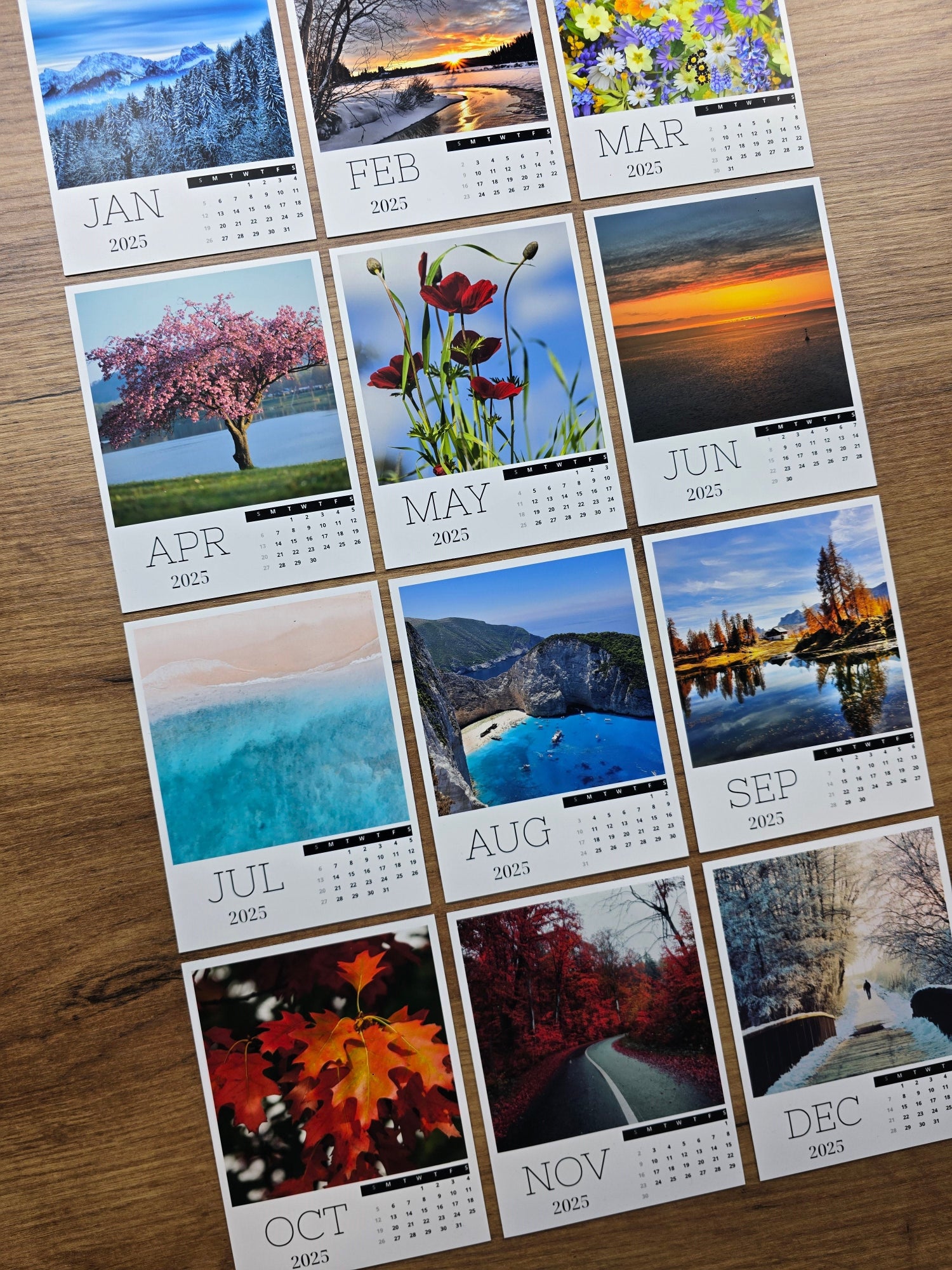 Small photo magnet calendar with monthly scenes on a wooden surface