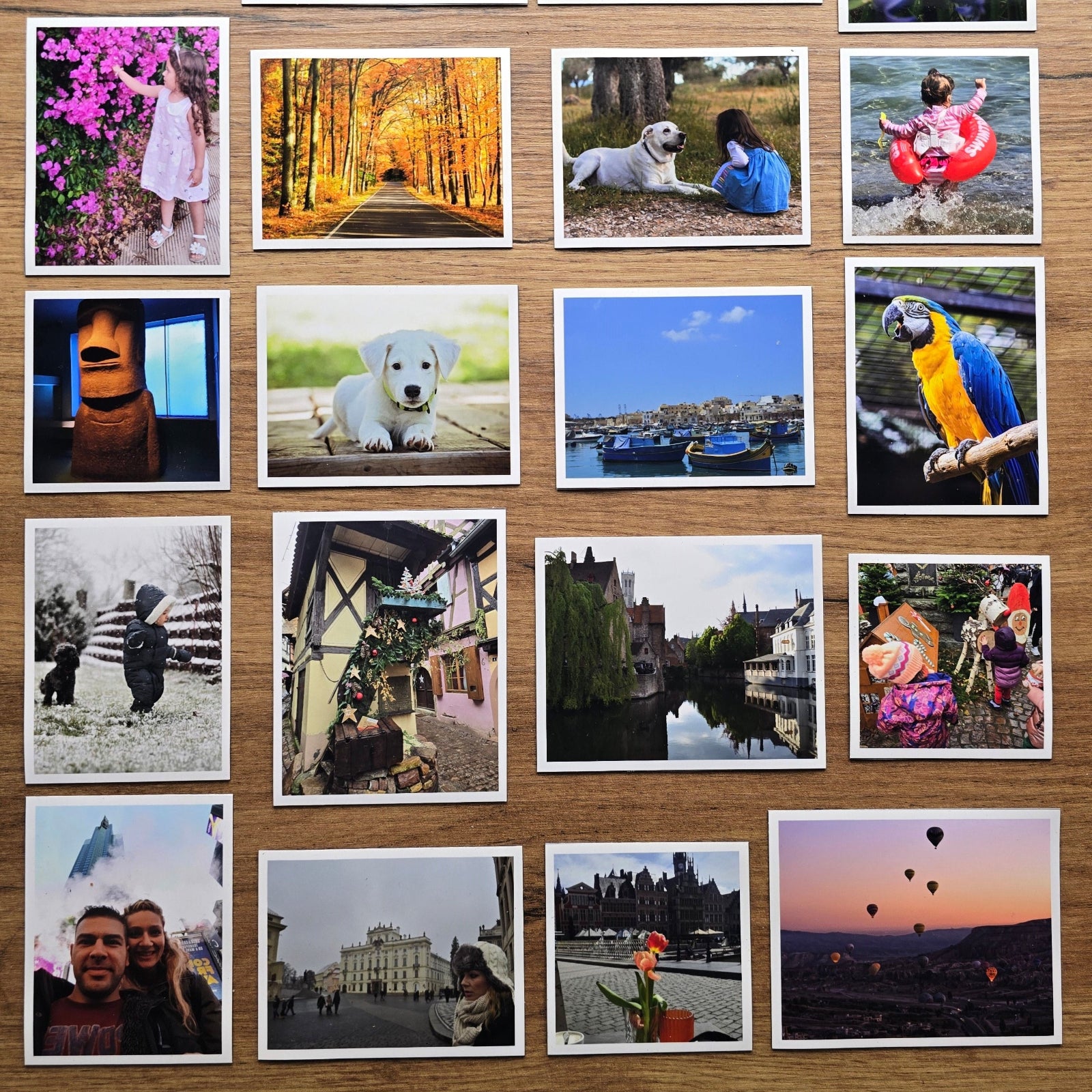 Collection of various photo magnets displayed on a wooden surface