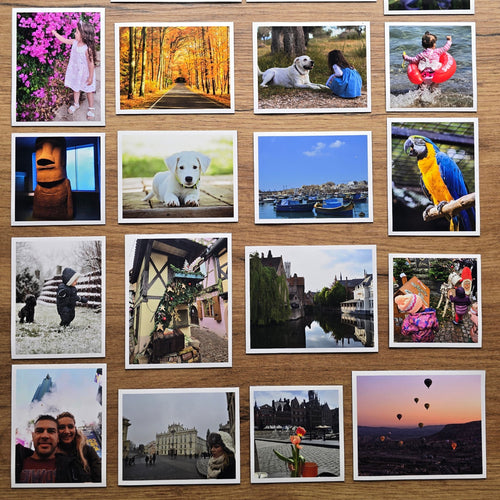 Collection of various photo magnets displayed on a wooden surface