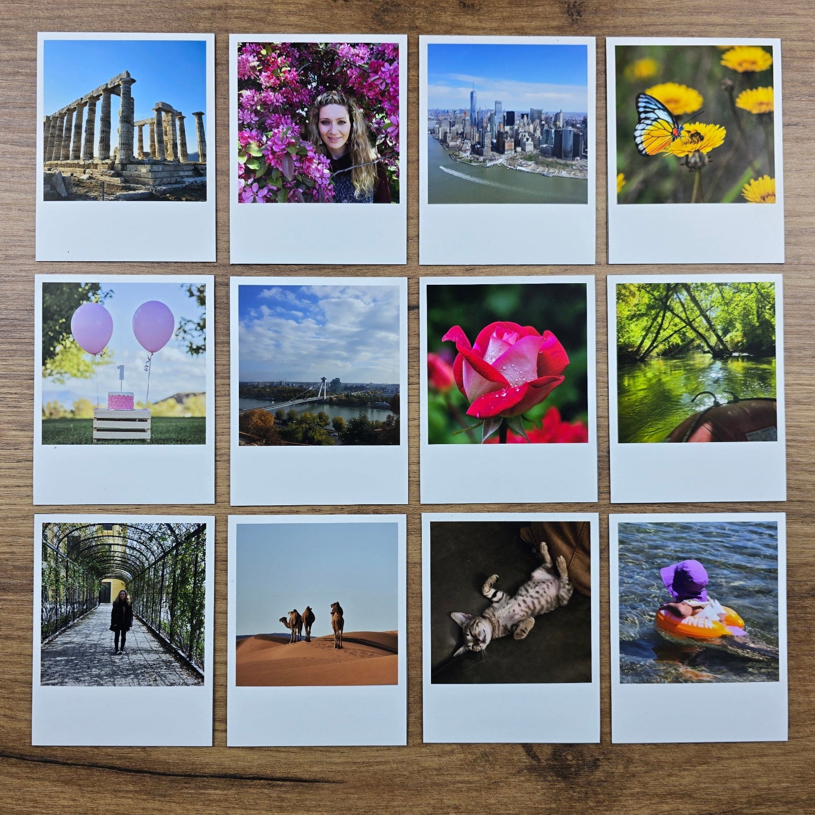 Collection of photo magnets arranged in a grid on a wooden surface